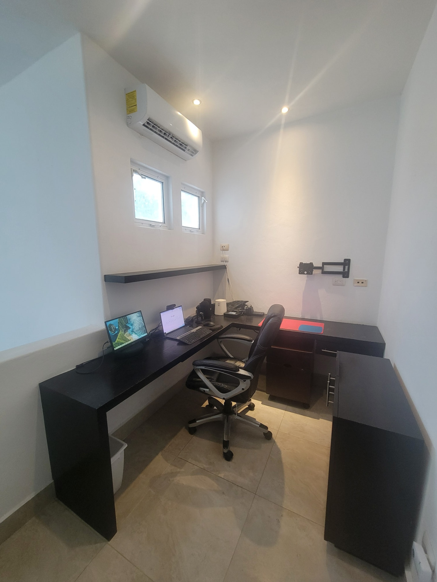 The home office in Cozumel where the founder works online: desk, laptops and networking equipment